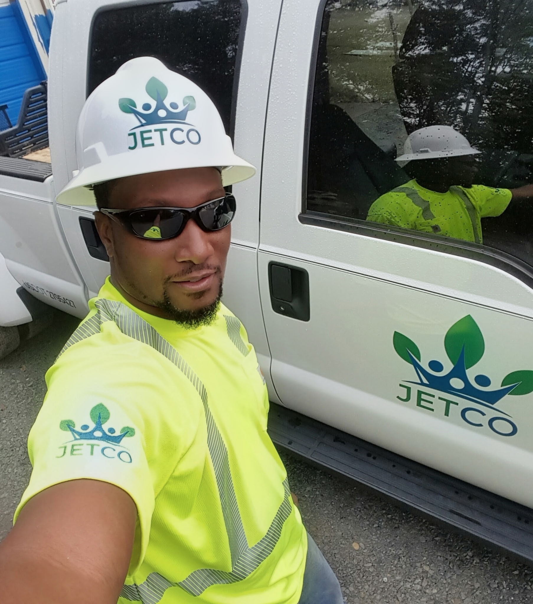 Eric wearing JETCO hard hat beside JETCO truck